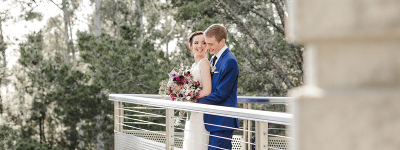 Bride and groom, with a background of the redwoods. 