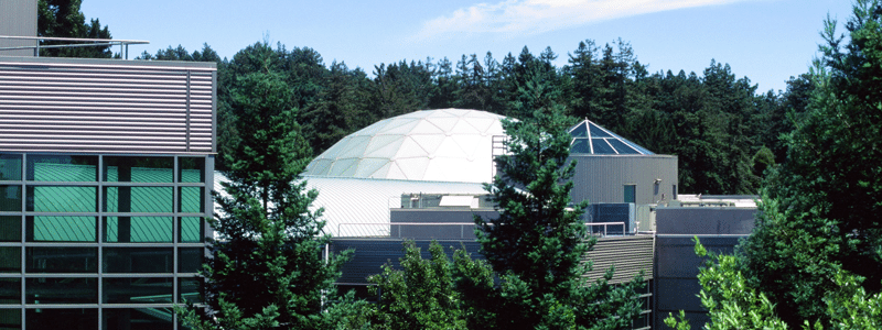 Chabot Space & Science Center building surrounded by redwoods during the day. 