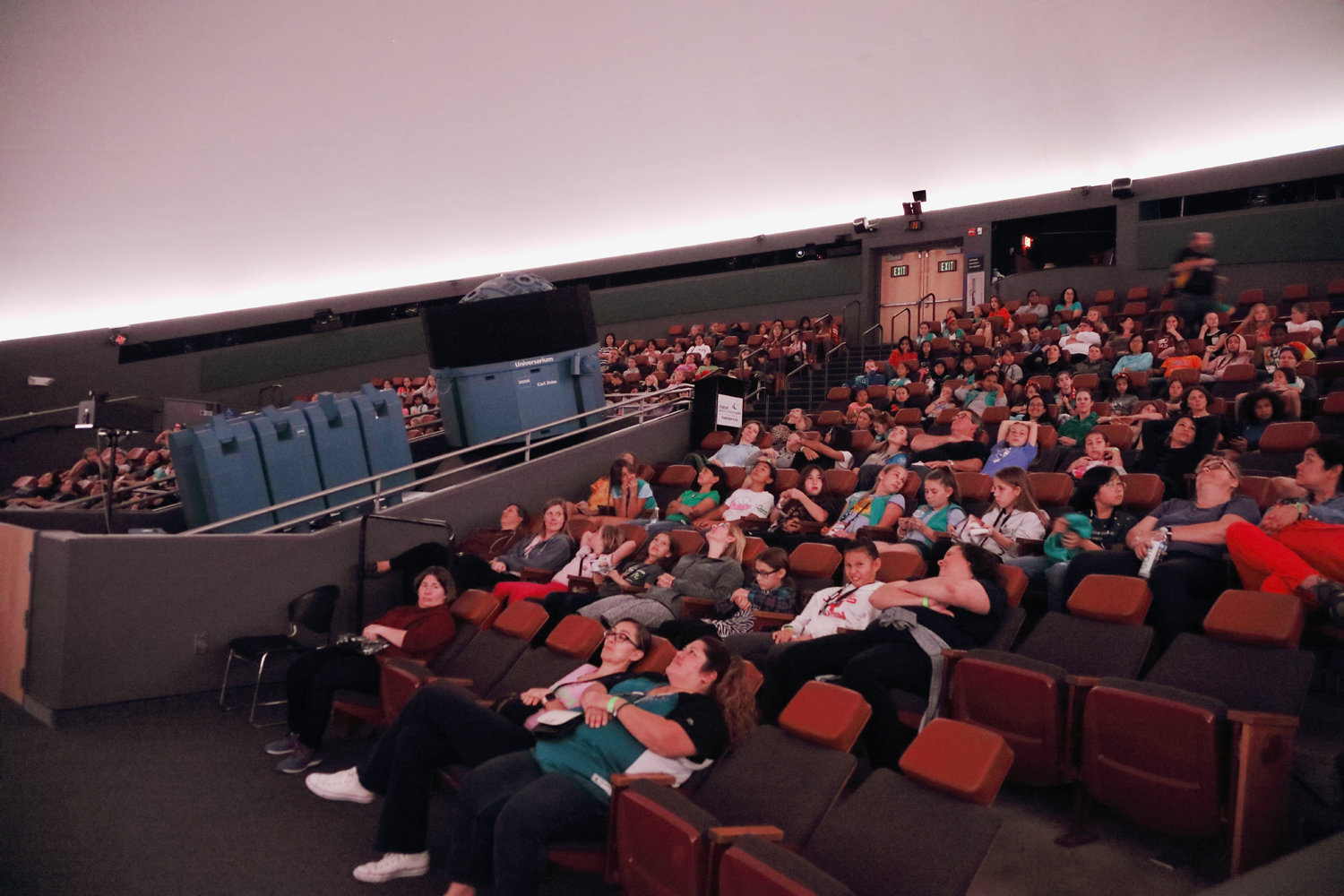 Visitors seated in the planetarium and preparing to watch a show. 