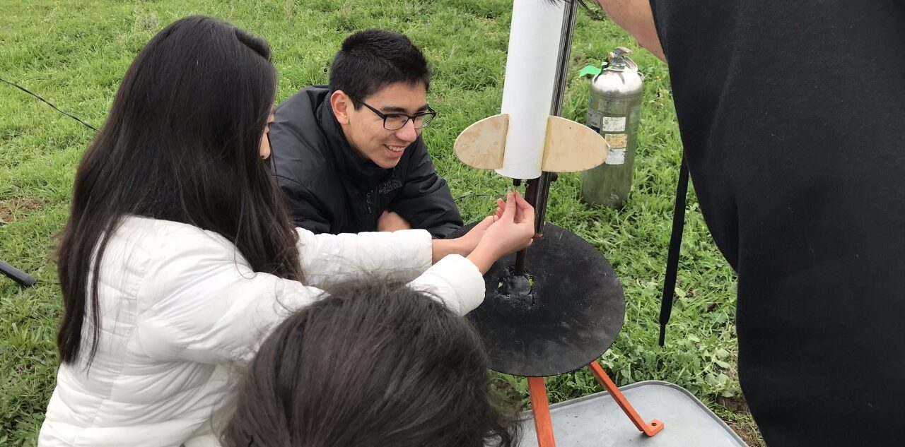 Two students who are Galaxy Explorers working outdoors on a project