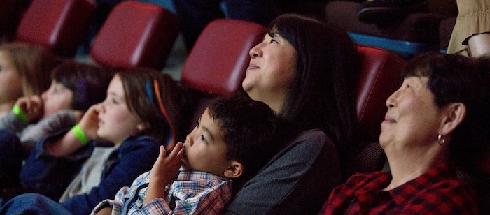 Visitors candidly sitting down and enjoying one of our shows in the 70-foot full dome planetarium. 